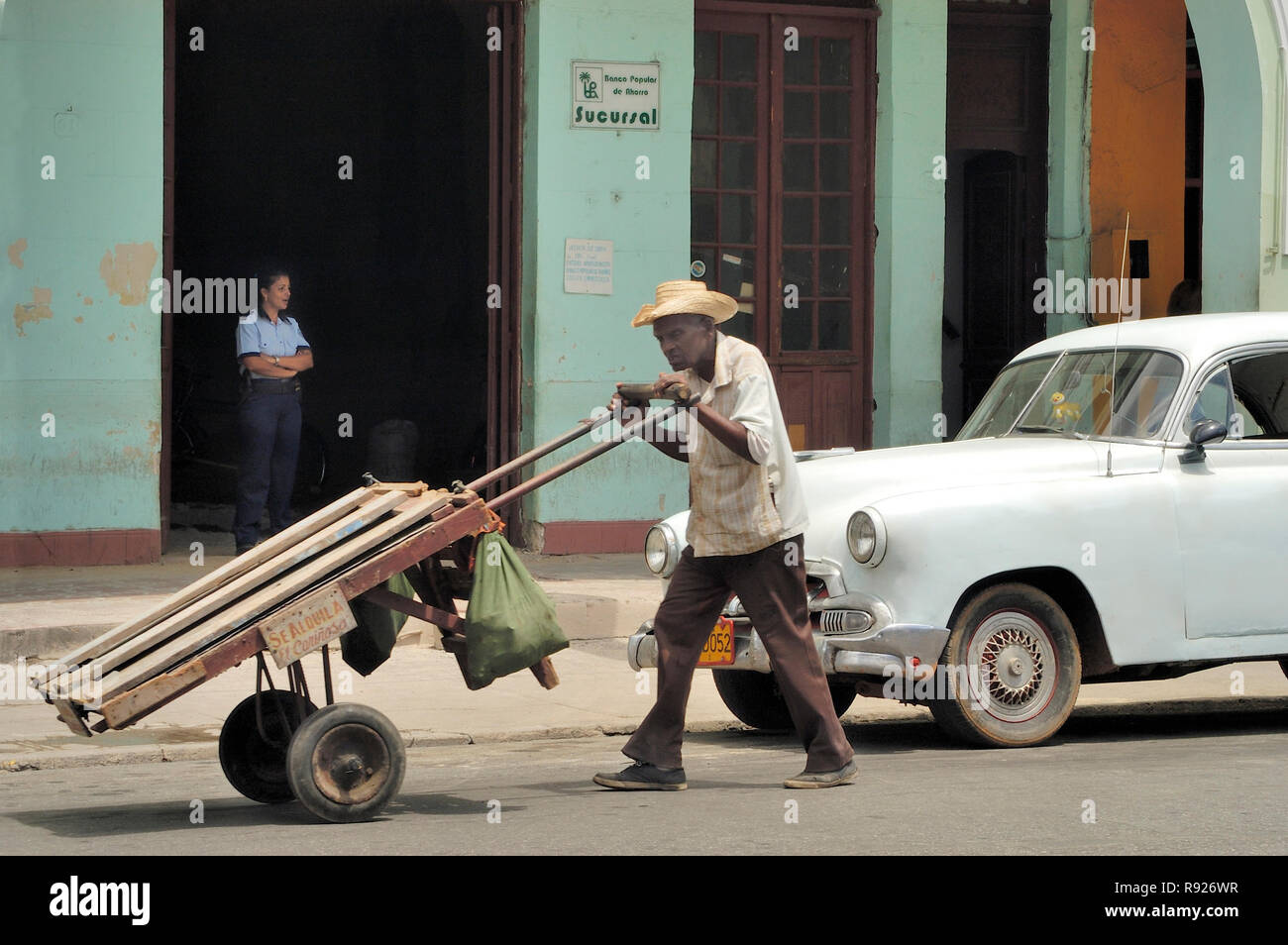 Granma, CubaApril 04,2016 Streetlife at Cuba. Man pushing a push car