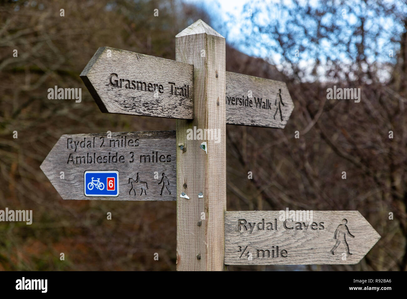 Wooden bridleway/footpath/cycle way sign showing the direction of Ambleside, Grasmere, Rydal and Rydal Caves.  Lake District, Cumbria, England, UK Stock Photo