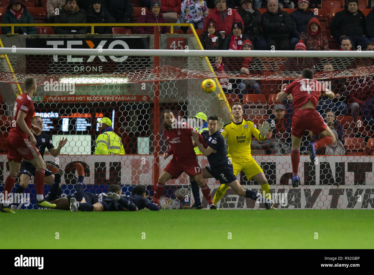 Pittodrie Stadium, Aberdeen, UK. 18th Dec, 2018. Ladbrokes Premiership football, Aberdeen versus Dundee; Andrew Considine of Aberdeen scores for 3-0 in the 50th minute Credit: Action Plus Sports/Alamy Live News Stock Photo