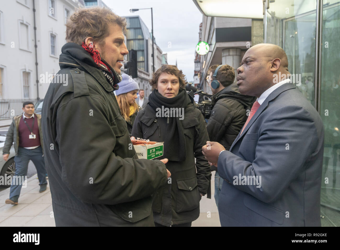 London, UK. 18th December 2018. Berlin community centre and pub Syndikat protesters talk with staff from their landlord, Global Real Estate Investors Limited, owned by the secretive Pears brothers, three of the richest men in the UK, who through various 'letterbox' companies own around 6200 properties in Berlin, against notice to quit after being open for 33 years in Berlin-Neukölln. Credit: Peter Marshall/Alamy Live News Stock Photo
