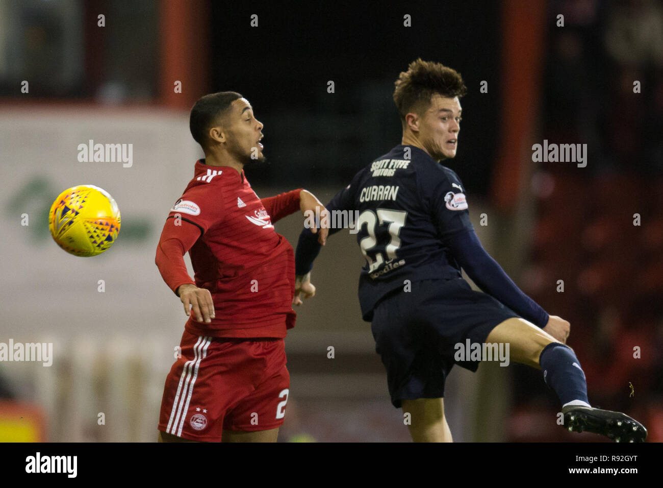 Pittodrie Stadium, Aberdeen, UK. 18th Dec, 2018. Ladbrokes Premiership football, Aberdeen versus Dundee; Jesse Curran of Dundee competes in the air with Max Lowe of Aberdeen Credit: Action Plus Sports/Alamy Live News Stock Photo