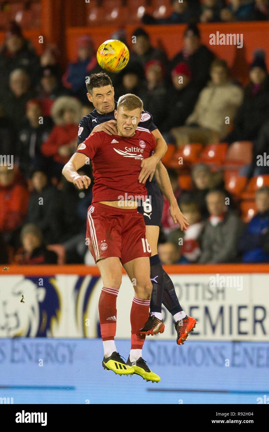Pittodrie Stadium, Aberdeen, UK. 18th Dec, 2018. Ladbrokes Premiership football, Aberdeen versus Dundee; Darren O'Dea of Dundee competes in the air with Sam Cosgrove of Aberdeen Credit: Action Plus Sports/Alamy Live News Stock Photo