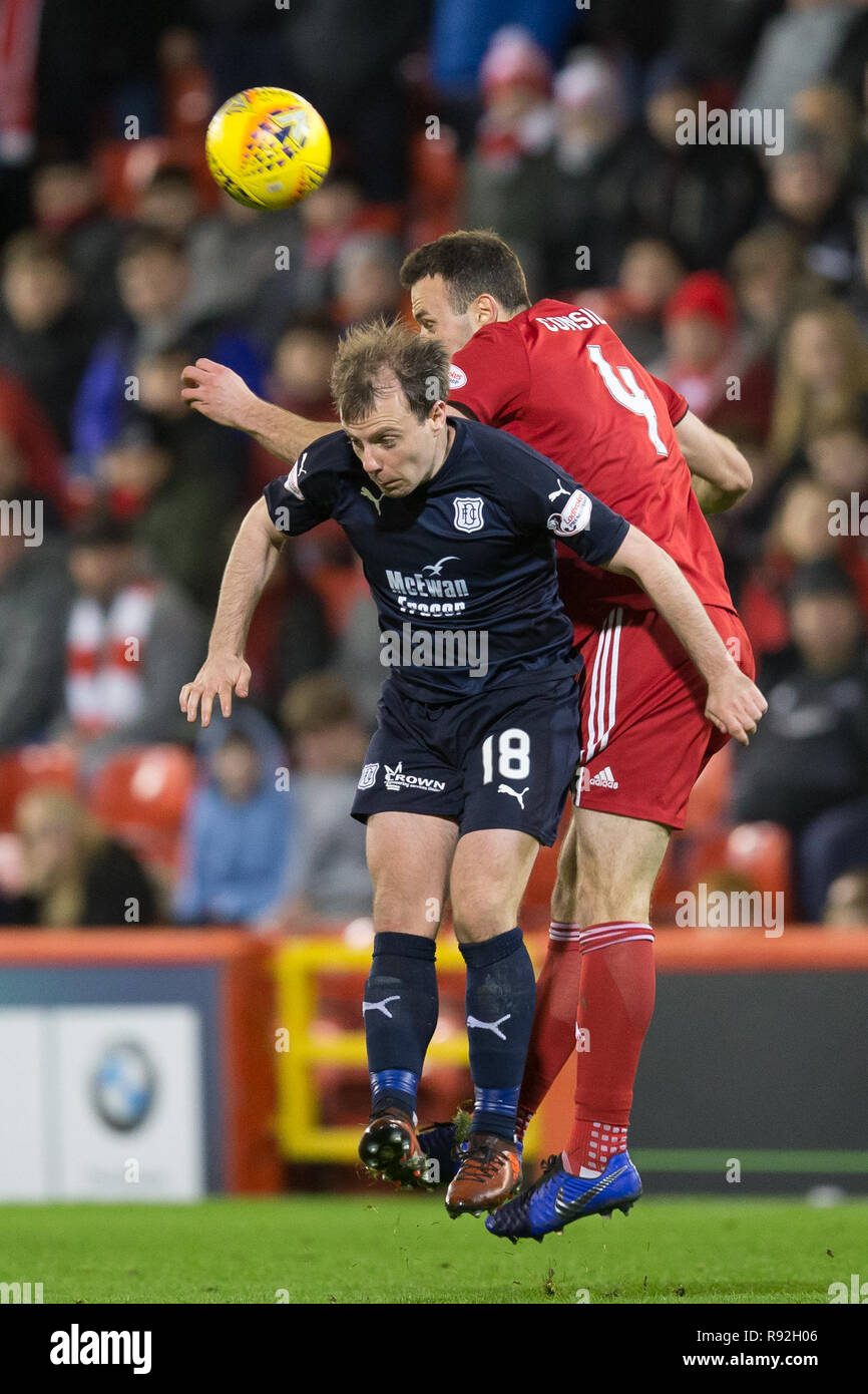 Pittodrie Stadium, Aberdeen, UK. 18th Dec, 2018. Ladbrokes Premiership football, Aberdeen versus Dundee; Paul McGowan of Dundee competes in the air with Andrew Considine of Aberdeen Credit: Action Plus Sports/Alamy Live News Stock Photo