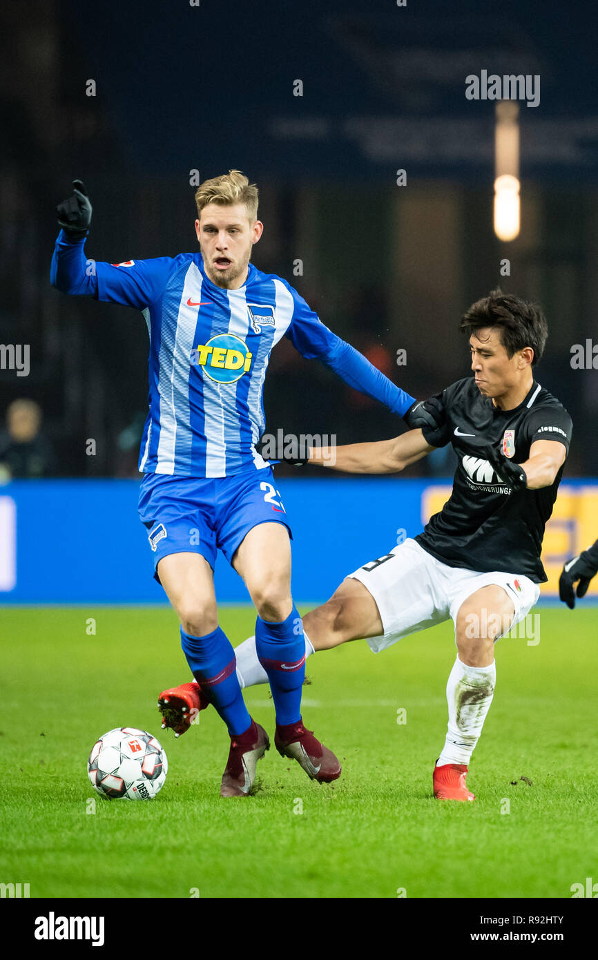 Berlin, Germany. 18th Dec, 2018. Arne Maier (L) of Hertha vies with Ja-cheol Koo of FC Augsburg during the Bundesliga match between Hertha BSC Berlin and FC Augsburg in Berlin, Germany, Dec. 18, 2018. The match ended in a 2-2 draw. Credit: Kevin Voigt/Xinhua/Alamy Live News Stock Photo
