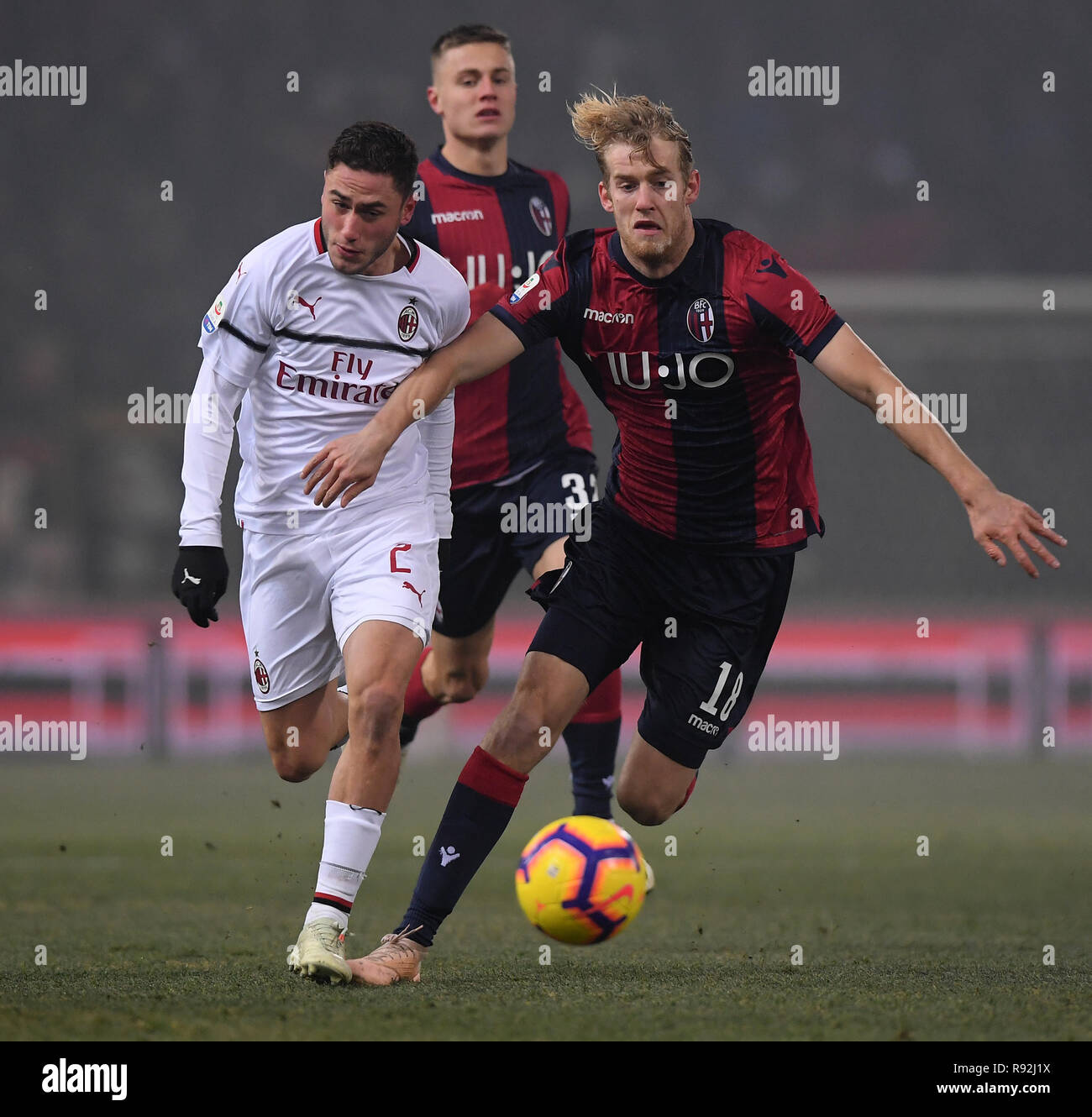 Bologna. 18th Dec, 2018. AC Milan's Davide Calabria (L) vies with Bologna's Filip Helander during the Serie A soccer match between Bologna and AC Milan in Bologna, Italy, Dec.18, 2018. The match ended in a 0-0 draw. Credit: Alberto Lingria/Xinhua/Alamy Live News Stock Photo