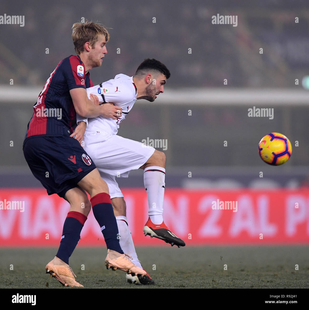Bologna. 18th Dec, 2018. AC Milan's Patrick Cutrone (R) vies with Bologna's Filip Helander during the Serie A soccer match between Bologna and AC Milan in Bologna, Italy, Dec.18, 2018. The match ended in a 0-0 draw. Credit: Alberto Lingria/Xinhua/Alamy Live News Stock Photo