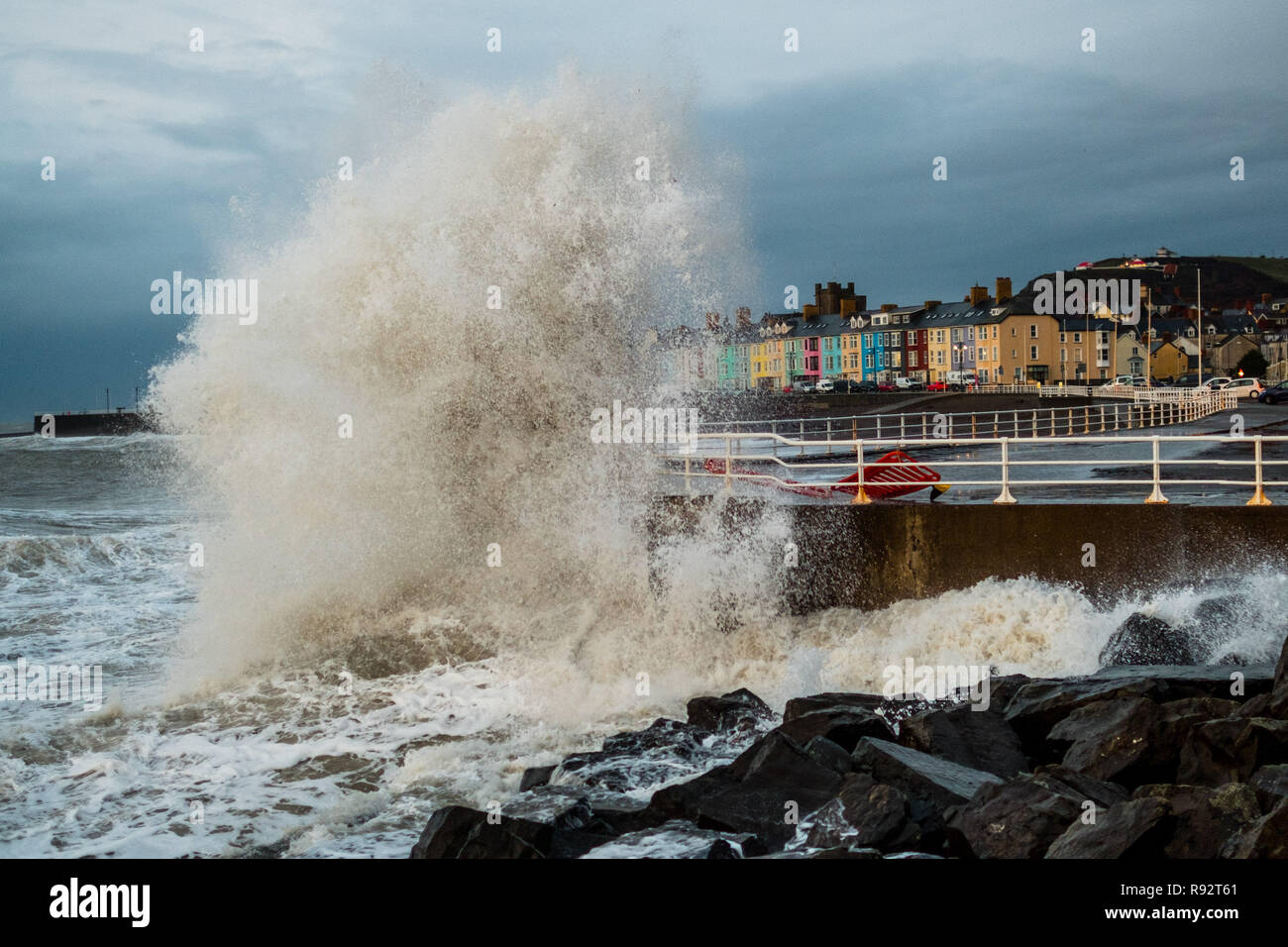 Aberystwyth Wales, UK. 19th Dec, 2018. UK Weather : Strong winds and a high tide combine to hammer huge waves against the sea defences in Aberystwyth on the Cardigan Bay coast of west Wales on a wert and blustery day, with more unsettled weather forecast for the coming days photo Credit: keith morris/Alamy Live News Stock Photo