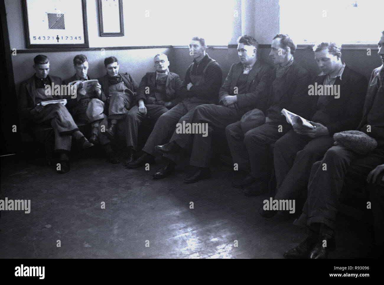1940s, historical, unemployed ex-mineworkers sitting in a room waiting ...