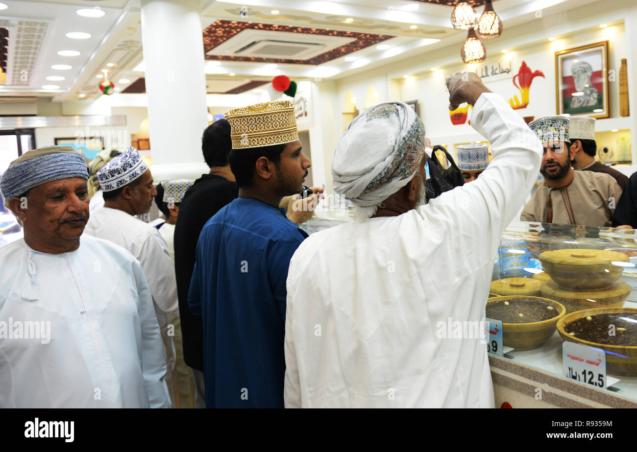 Omani Halwa vendor at the colorful market in Nizwa, Oman Stock Photo