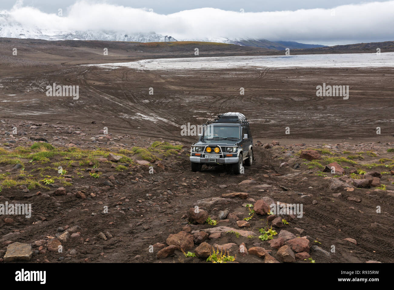 Extreme off-road expedition car Toyota Land Cruiser Prado driving on mountain road Stock Photo