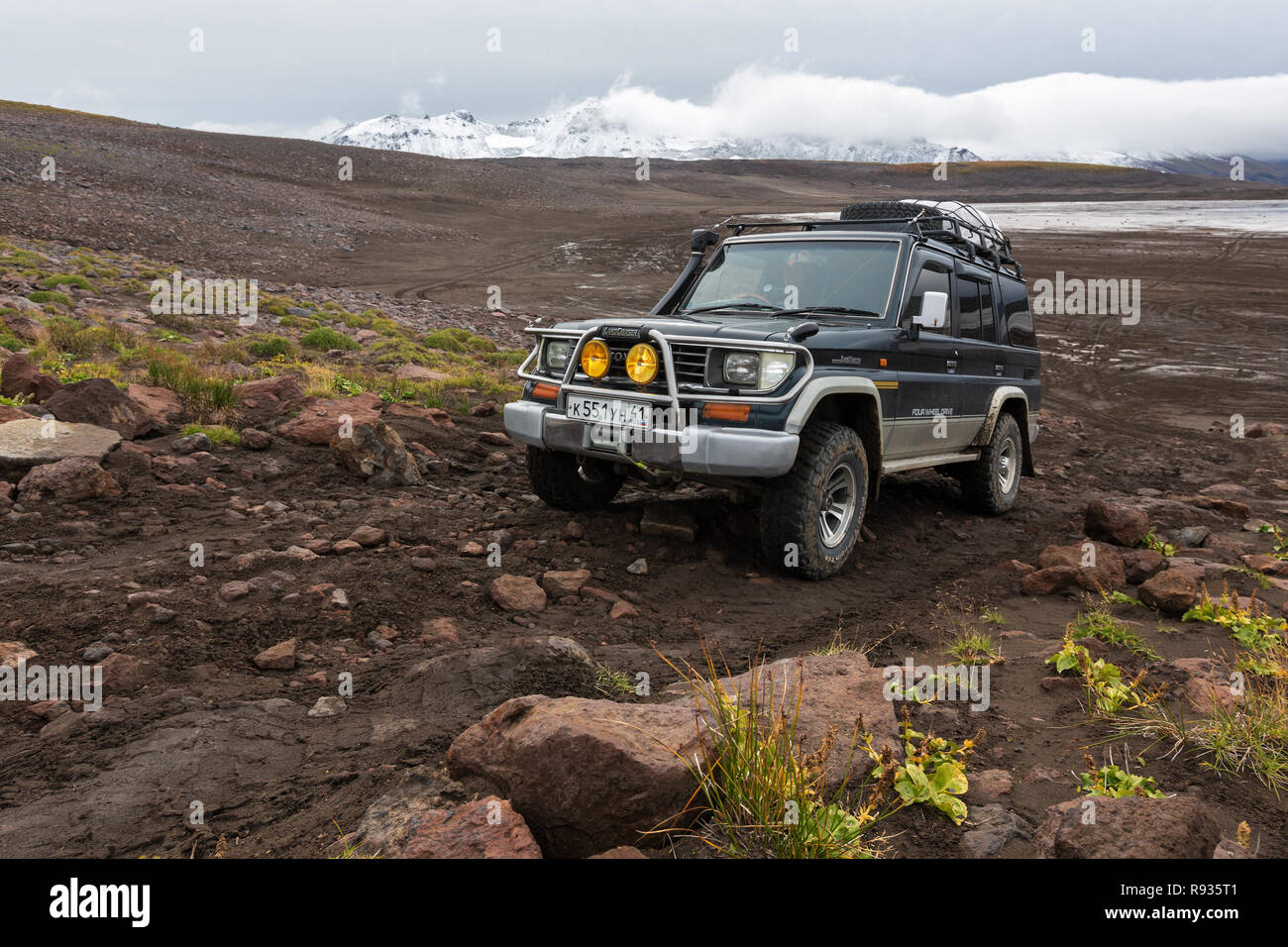 Extreme off-road expedition auto Toyota Land Cruiser Prado driving on mountain road Stock Photo