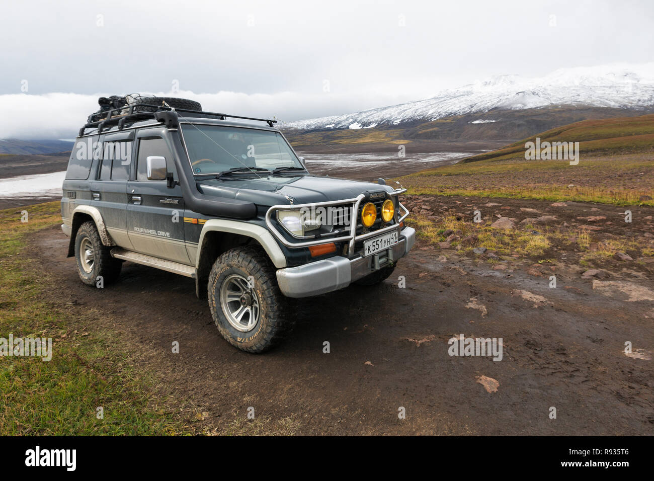 Extreme off-road expedition auto Toyota Land Cruiser Prado (70 series) parked on mountain road Stock Photo