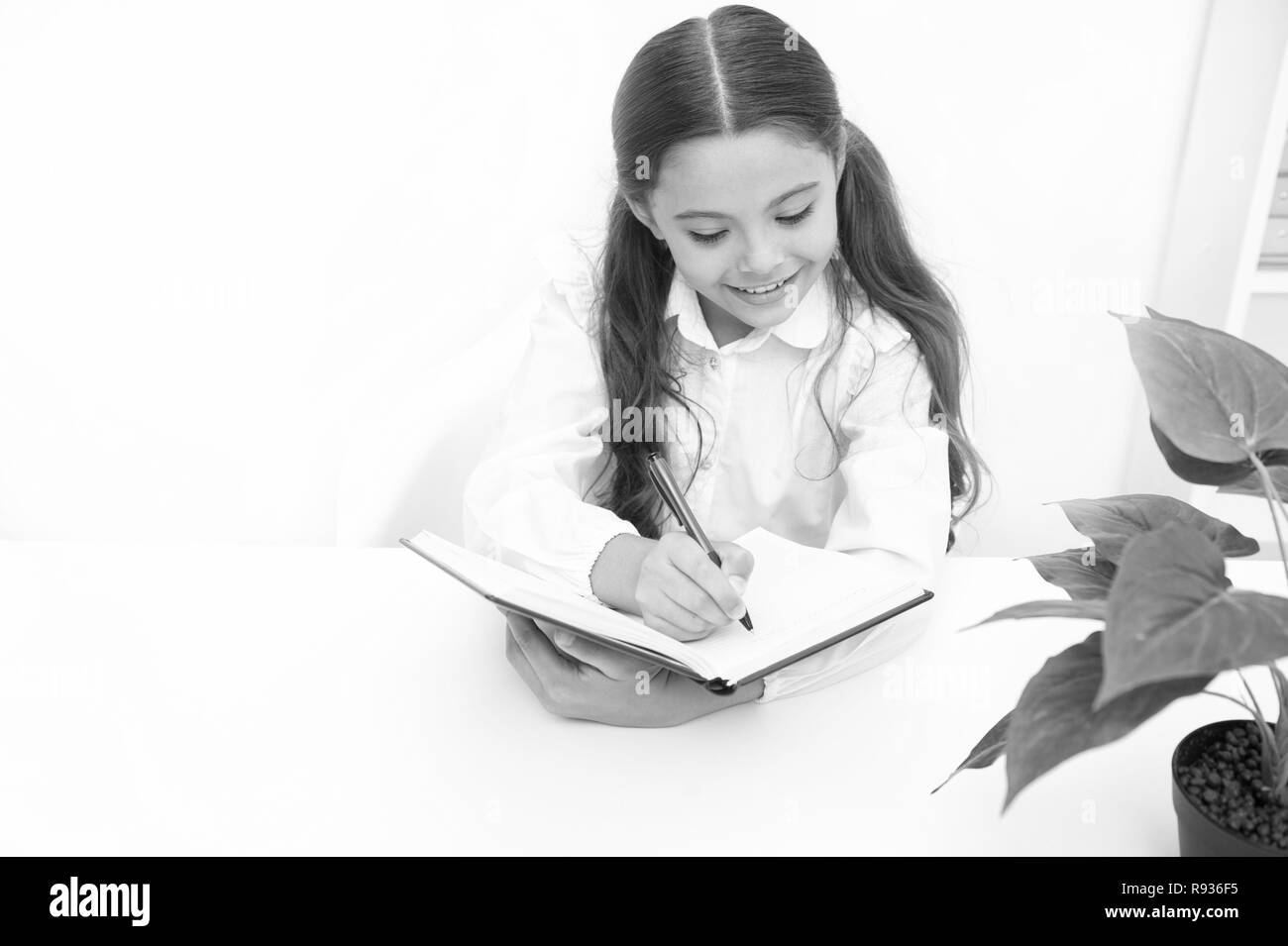 Knowledge concept. School girl write at lesson, knowledge. Knowledge day. If knowledge you need you must read. Stock Photo
