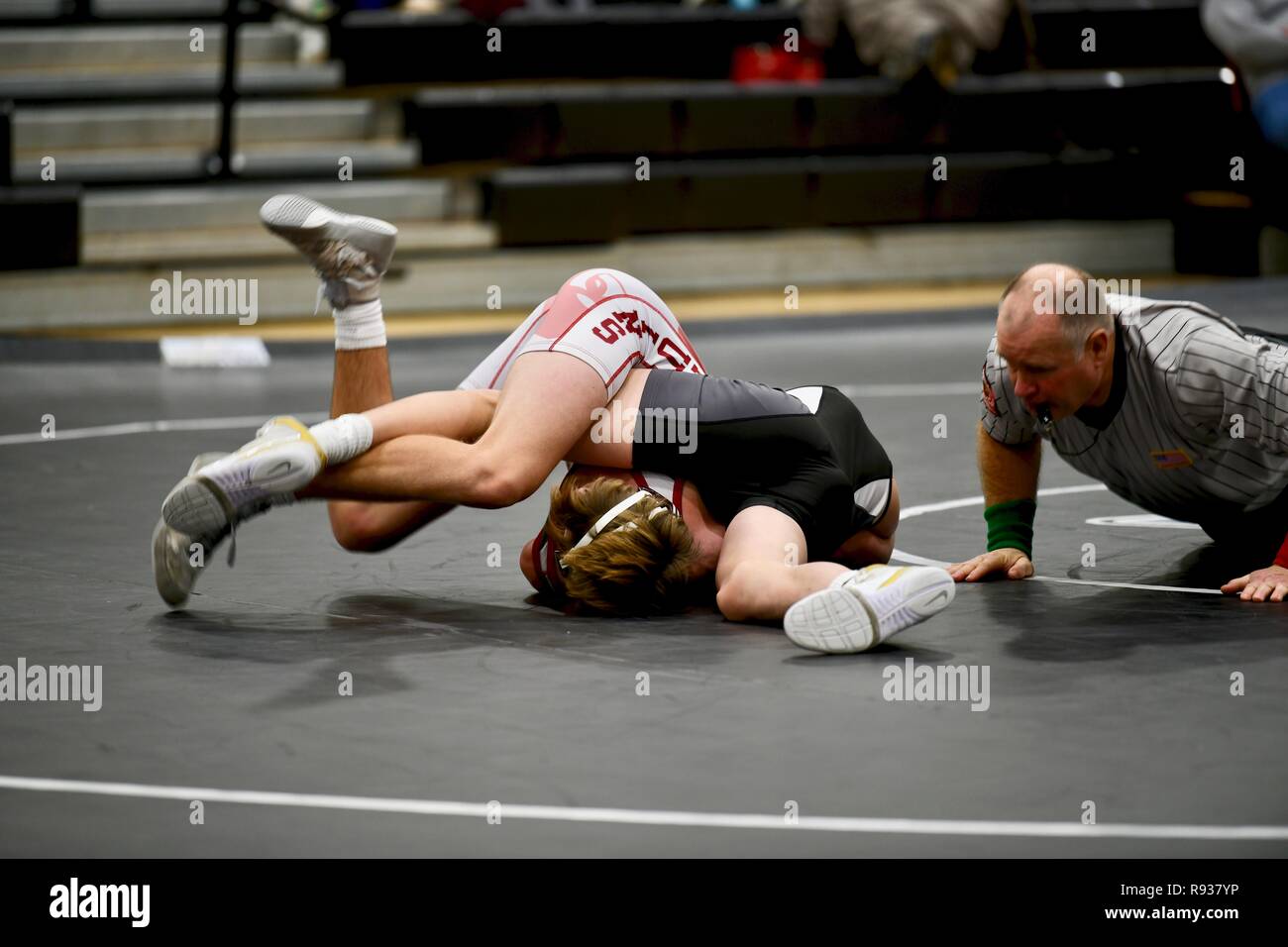 High school wrestler getting pinned by his opponent. Stock Photo