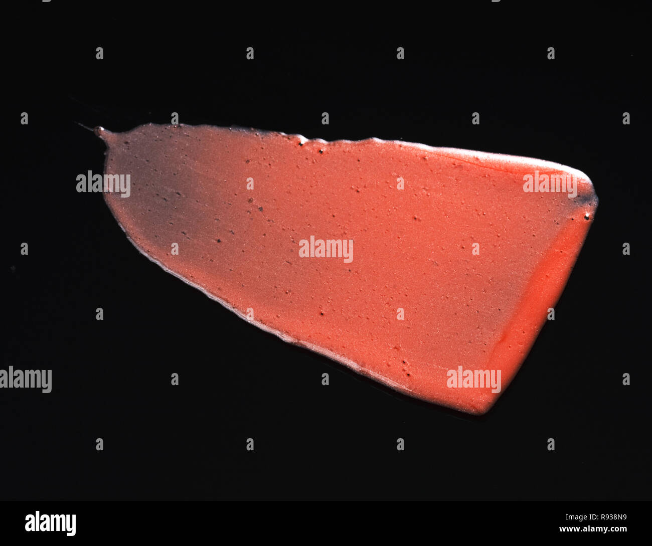 Texture of Red Lipgloss Liquid, Black Background Stock Photo