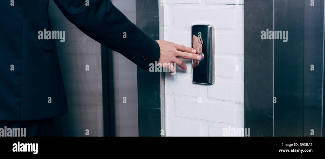 cropped view of man pressing elevator button Stock Photo