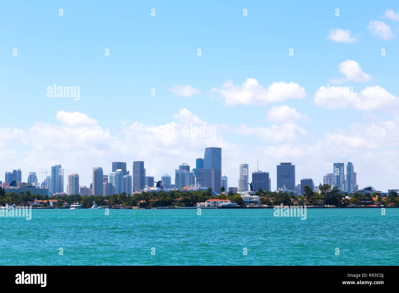 Cloudy sky over the water and Miami city, Florida. A view on Miami city skyline from Miami Beach waterfront. Stock Photo