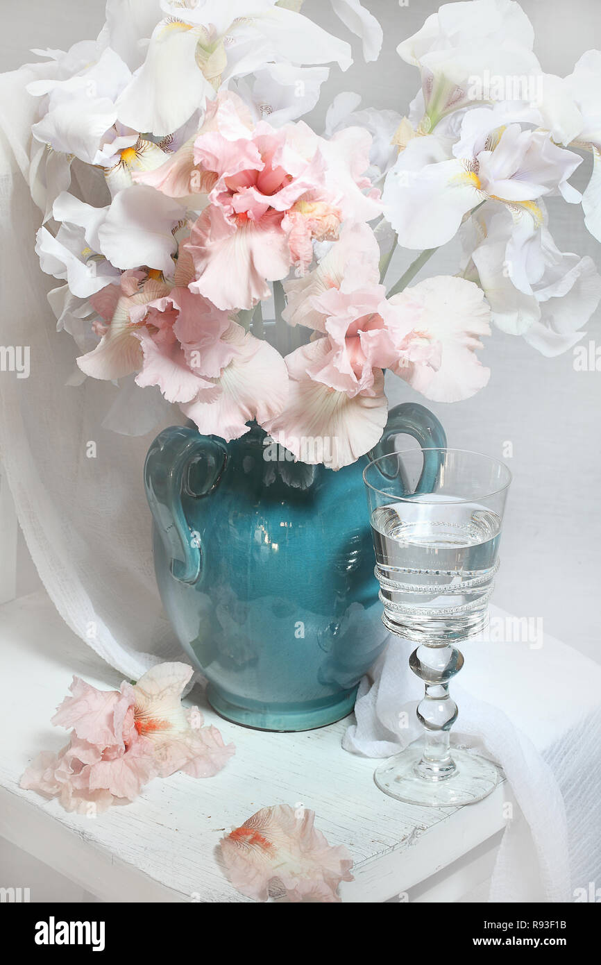Still life with a bouquet of irises and white wine Stock Photo - Alamy