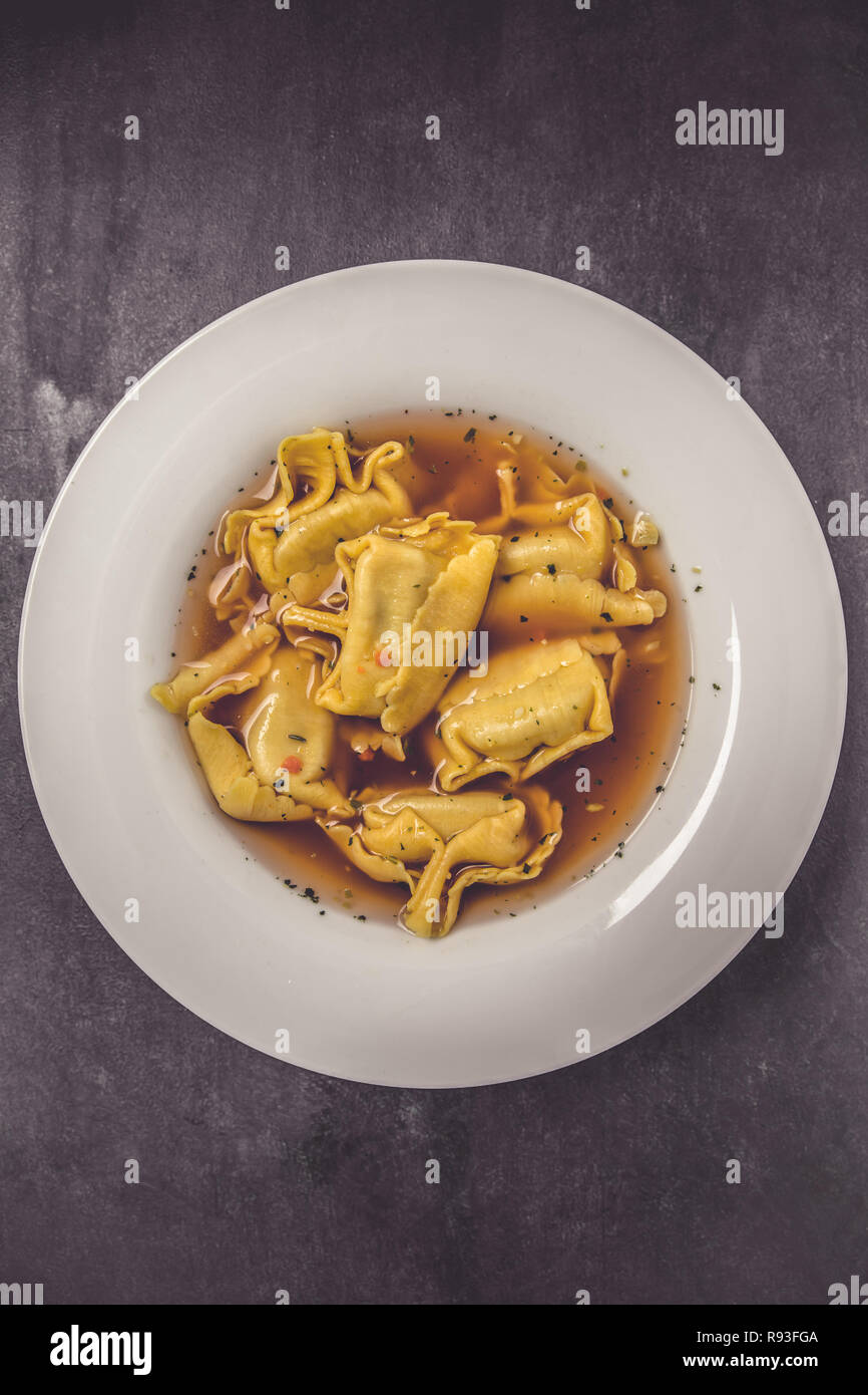 Homemade tortellini in broth in a top view Stock Photo Alamy