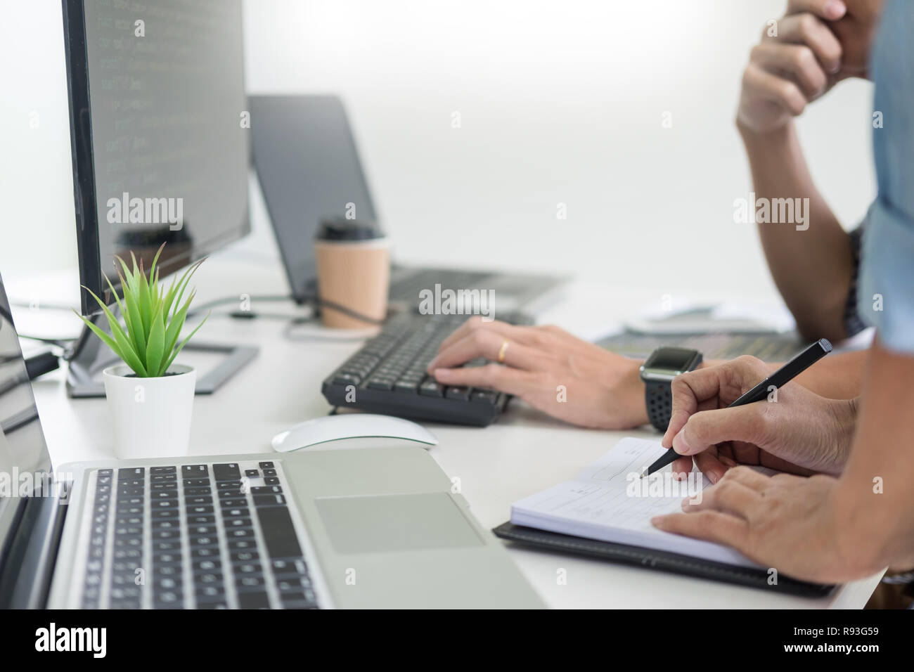 Asian team Outsource Developer Looking Screen Programming Code Working with Laptop Computer Software Stock Photo