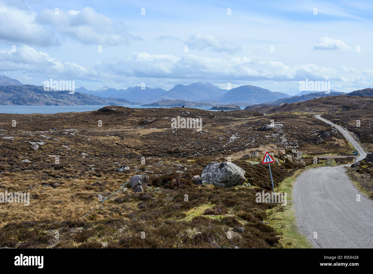 Single-track road with distant view of Loch Torridon and the Torridon Mountains, Applecross Peninsula, Wester Ross, Highland Region, Scotland Stock Photo