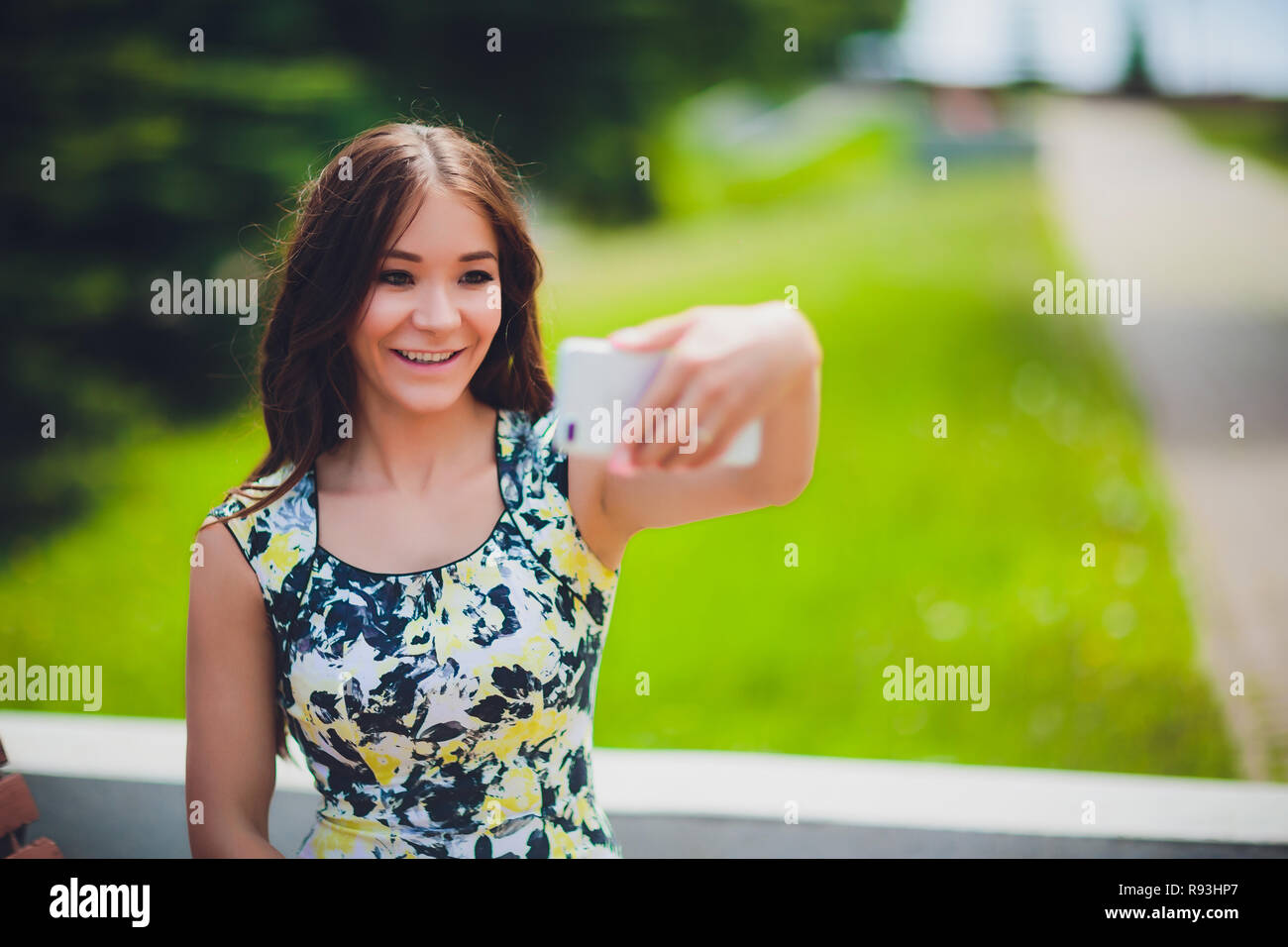 Close up sunny portrait of young happy pretty girl making selfie and ...