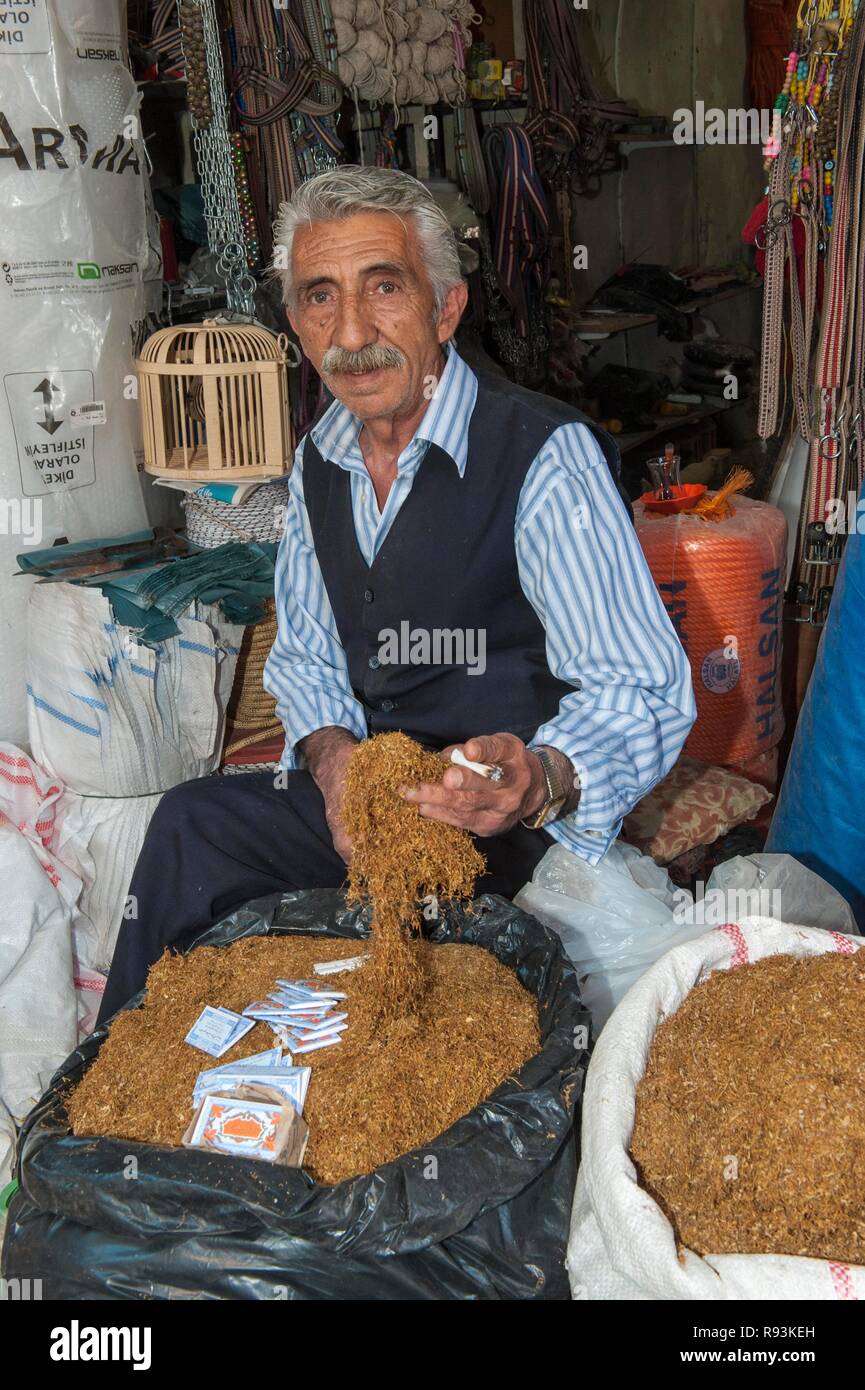 Man selling tobacco, Mardin market, Anatolia, Eastern Turkey Stock Photo
