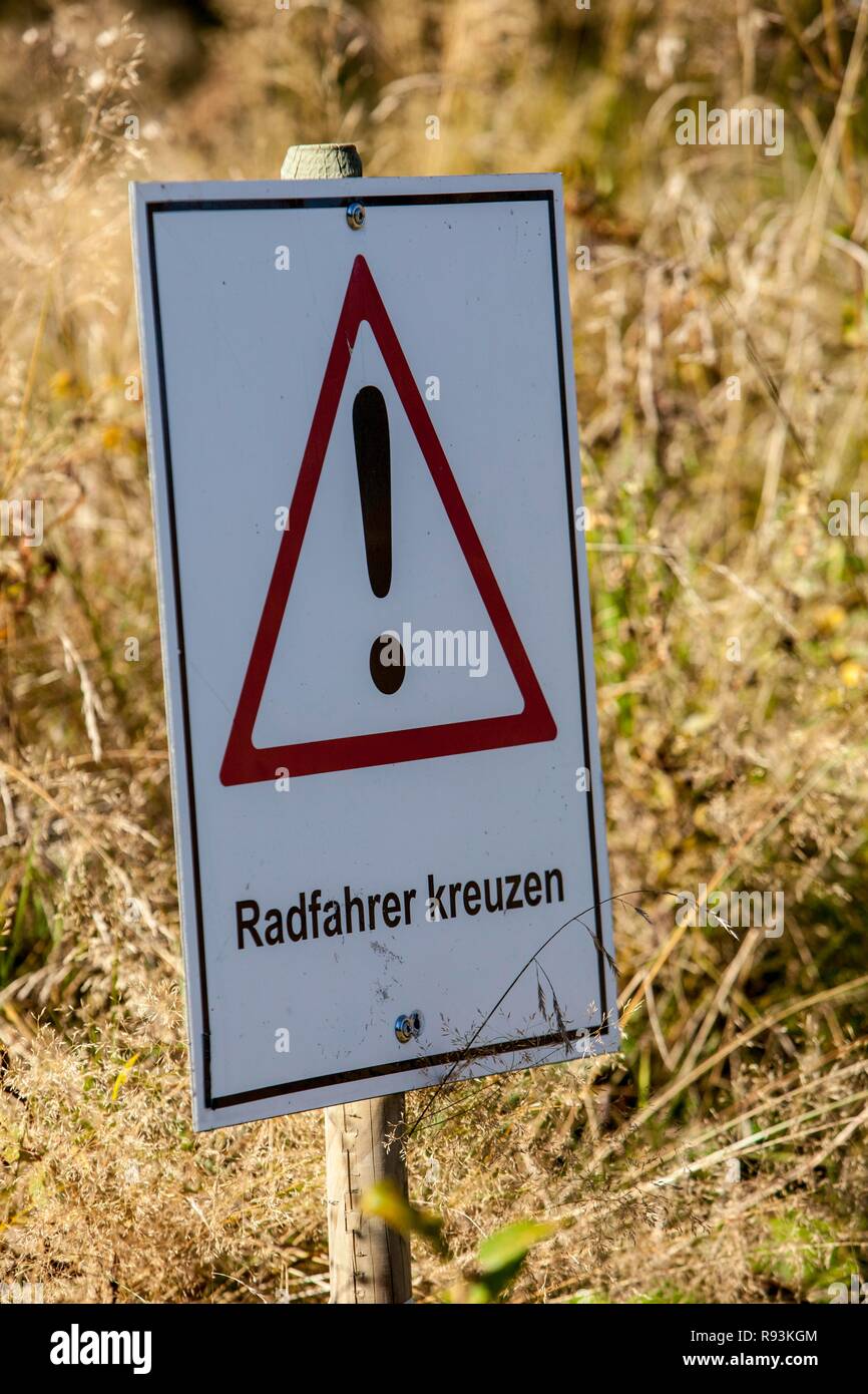 Warning sign, lettering 'Radfahrer kreuzen', German for 'cyclists crossing', bike park, downhill mountain bike trail at the Stock Photo