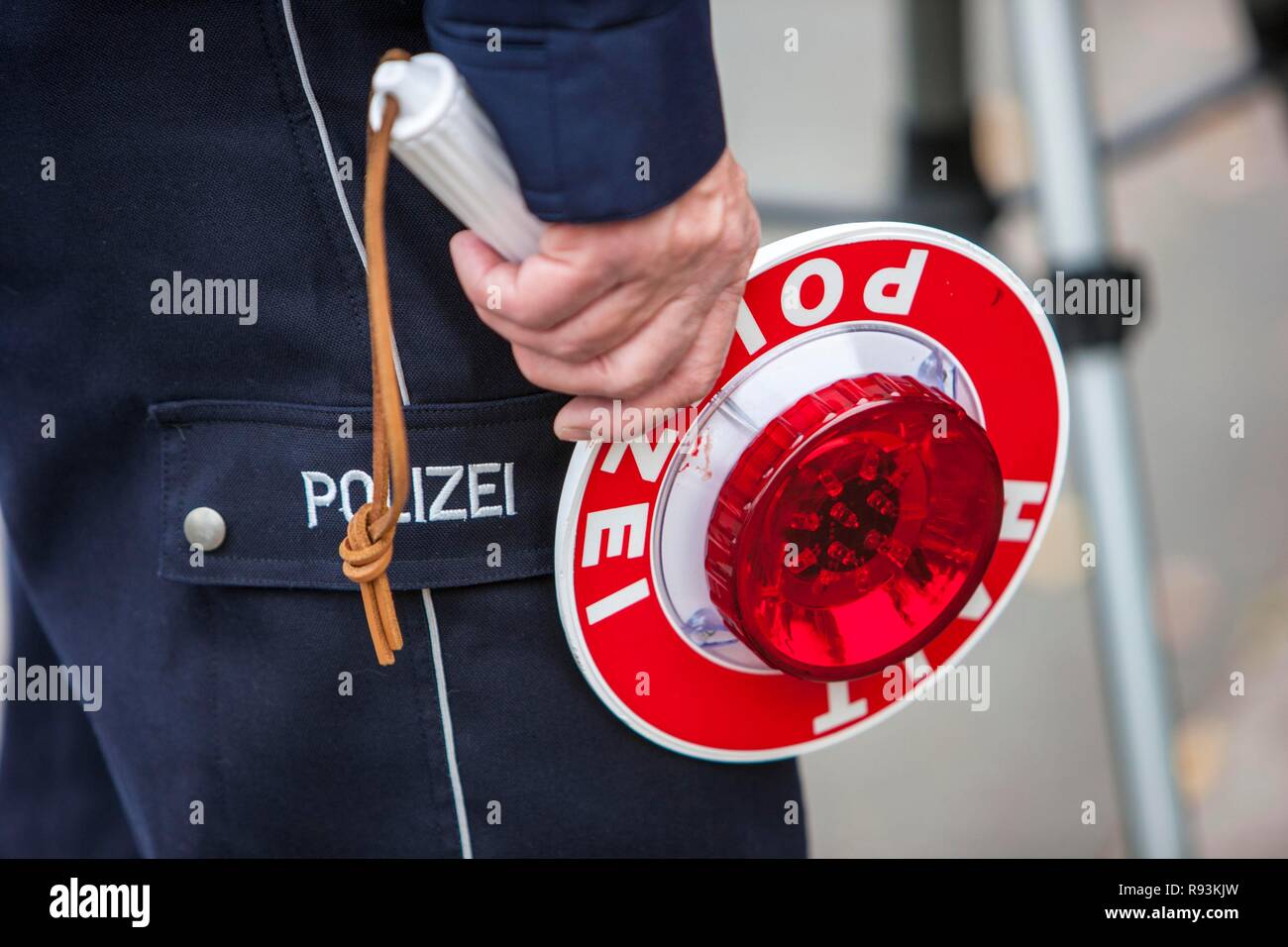 Policeman holding a signalling disc, extensive speed controls in North Rhine-Westphalia on 24.10.2012, Recklinghausen Stock Photo