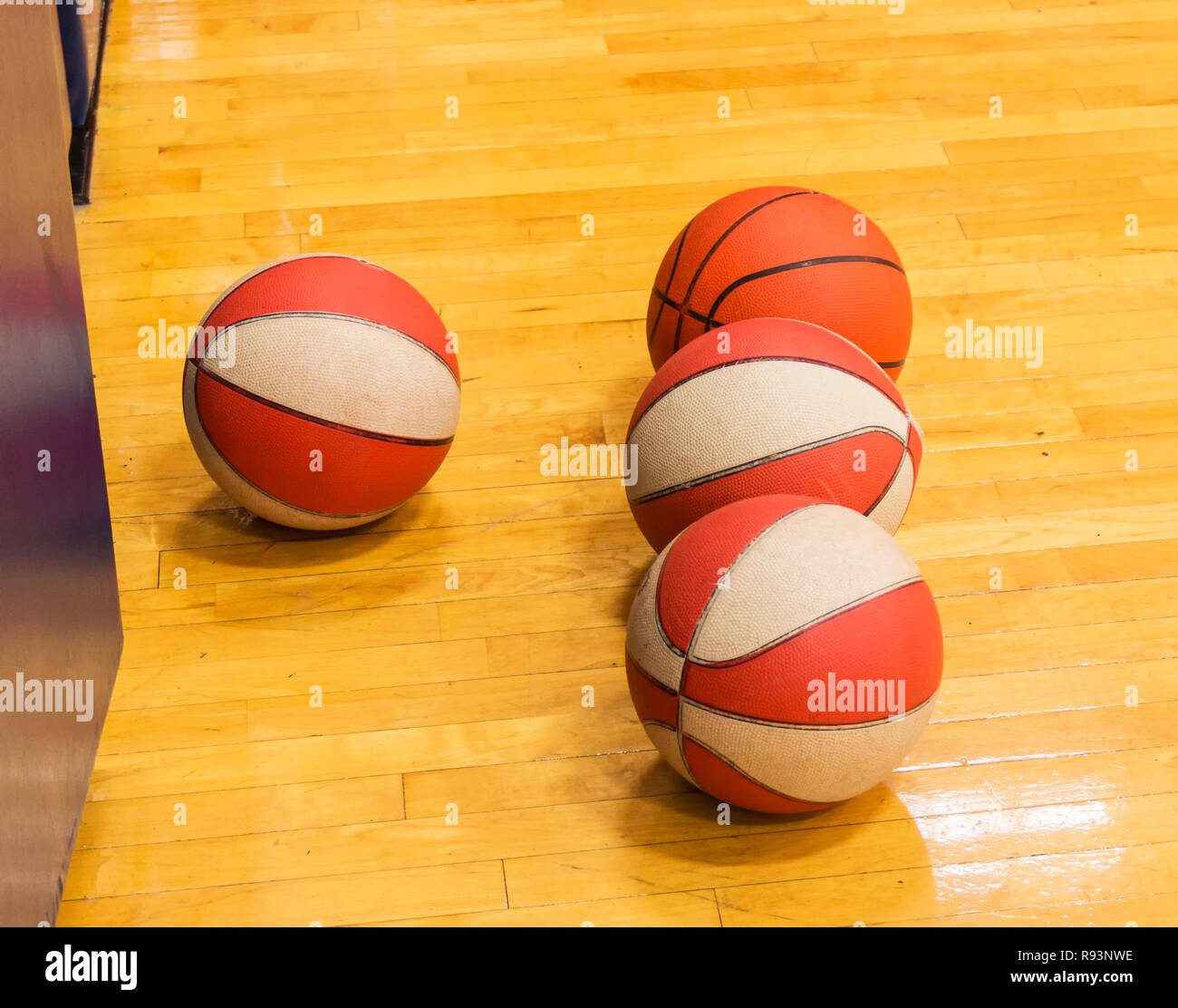 Four basketballs isolated on a gym floor during basketball practice at