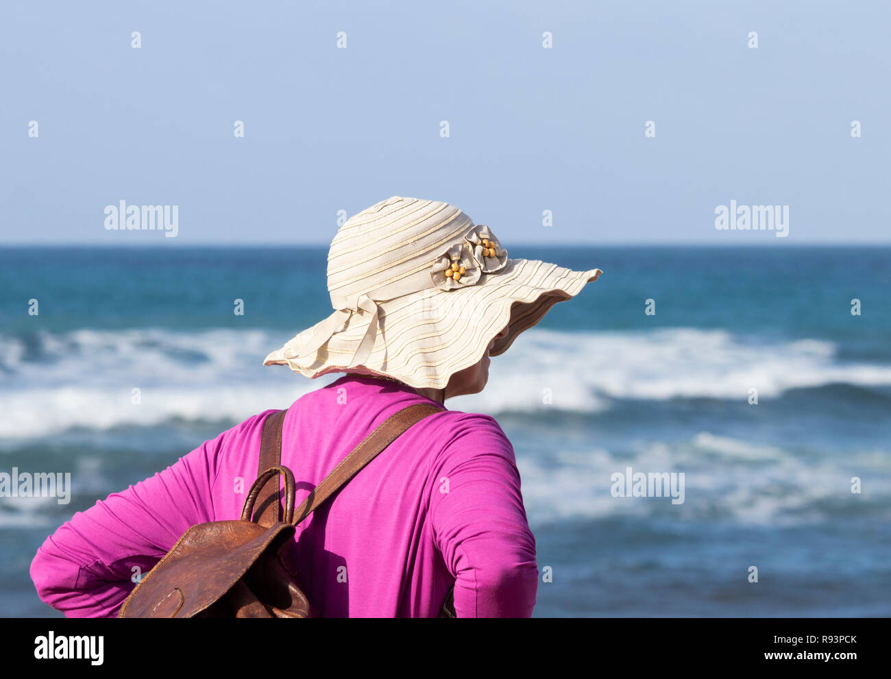 Rear view of mature woman on holiday looking out over the sea Stock ...