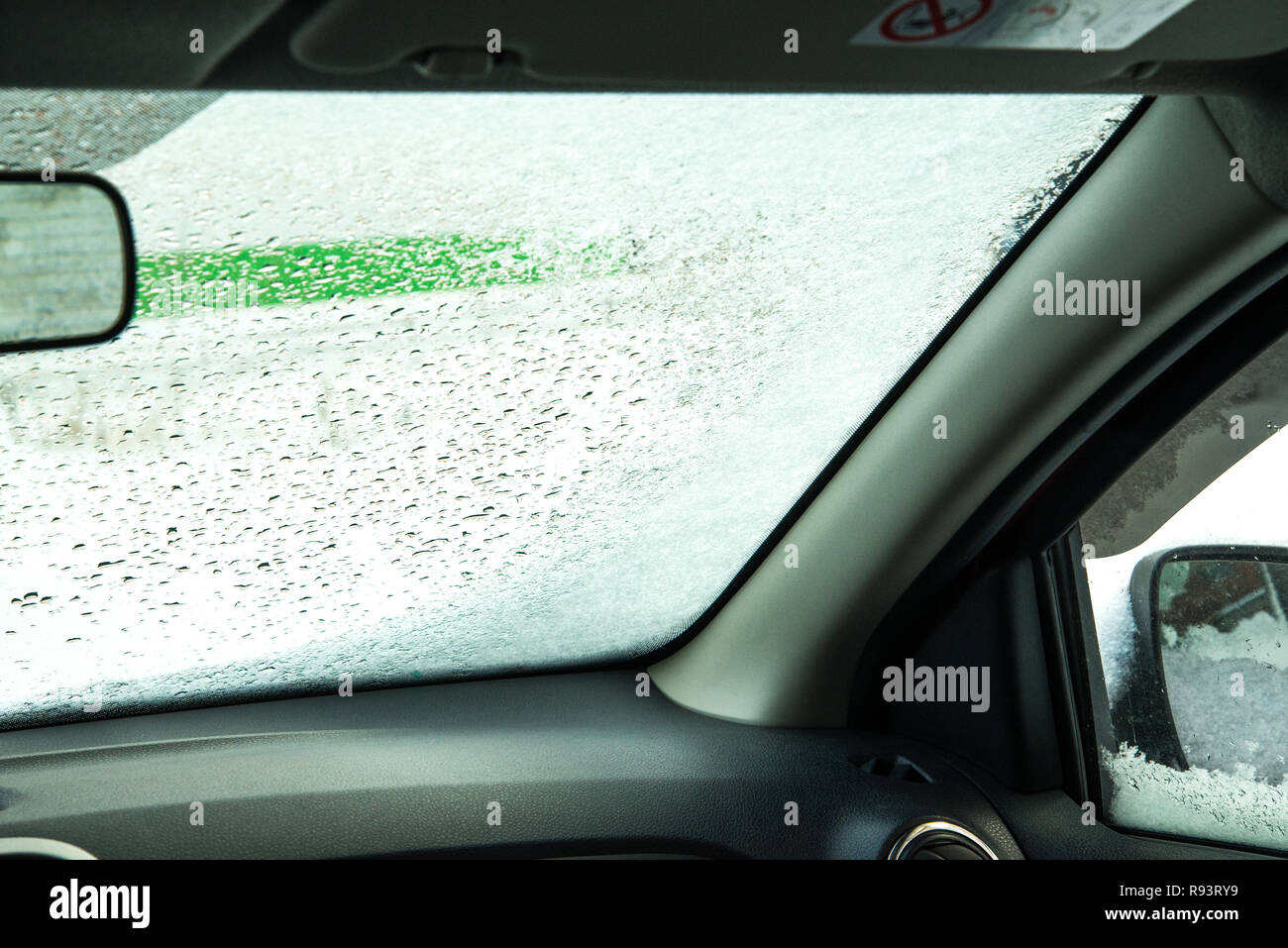 car window under a layer of snow internal look,Winter frozen car