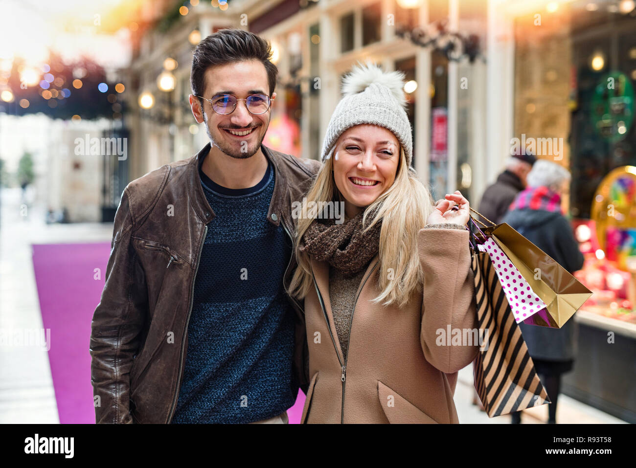 Christmas shopping in a mall for a young couple Stock Photo