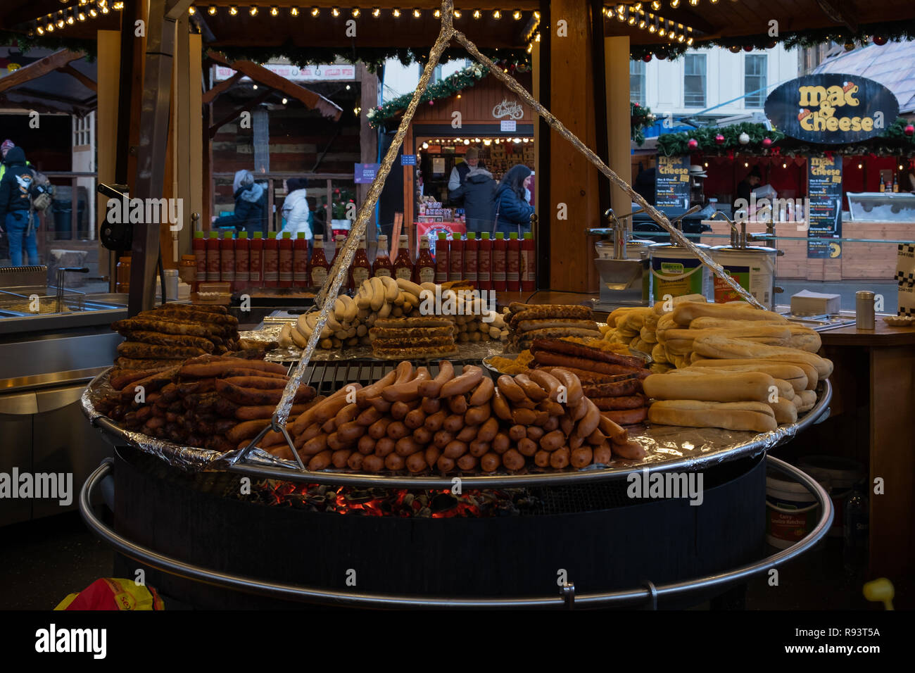 Glasgow, Scotland, UK - December 14, 2018: A giant hanging roasting pit for varied selection of cooked sausages and burgers at the Glasgow Christmas f Stock Photo