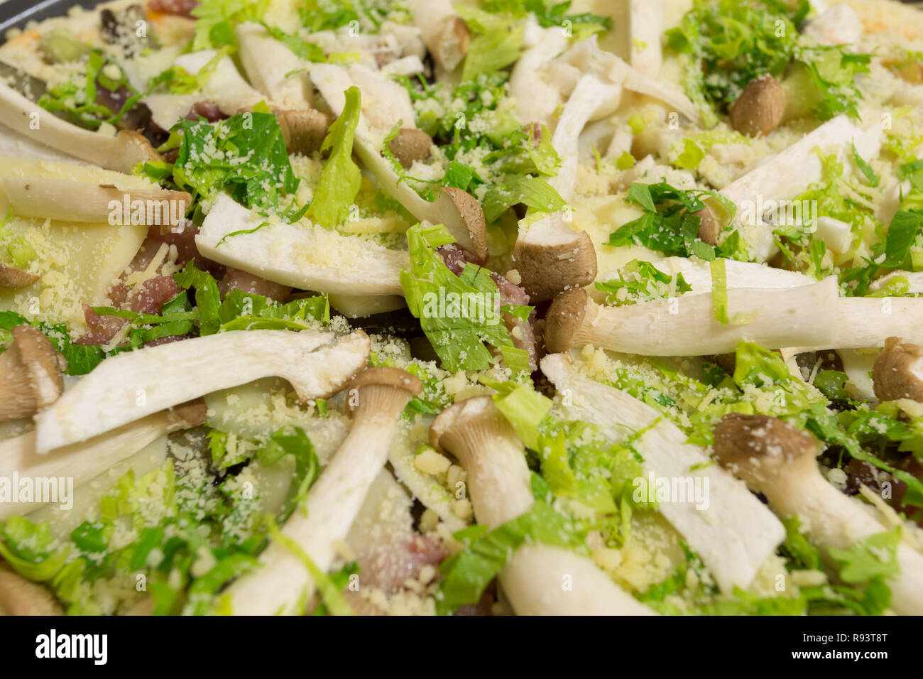 Fresh homemade pizza ready to bake, with King Trumpet mushroom