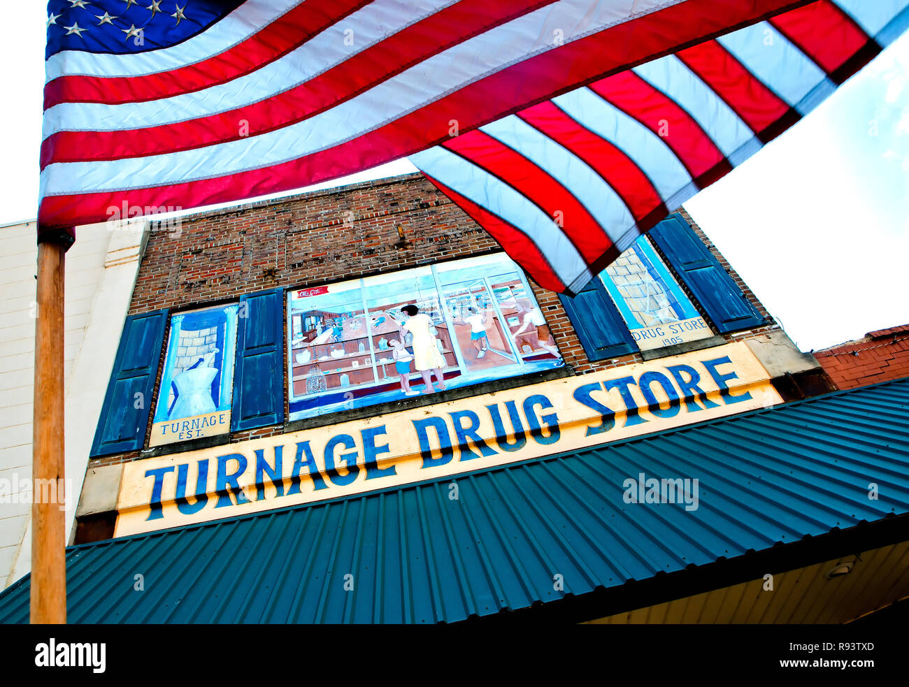 An American flag waves outside Turnage Drug Store in Water Valley, Mississippi. Stock Photo