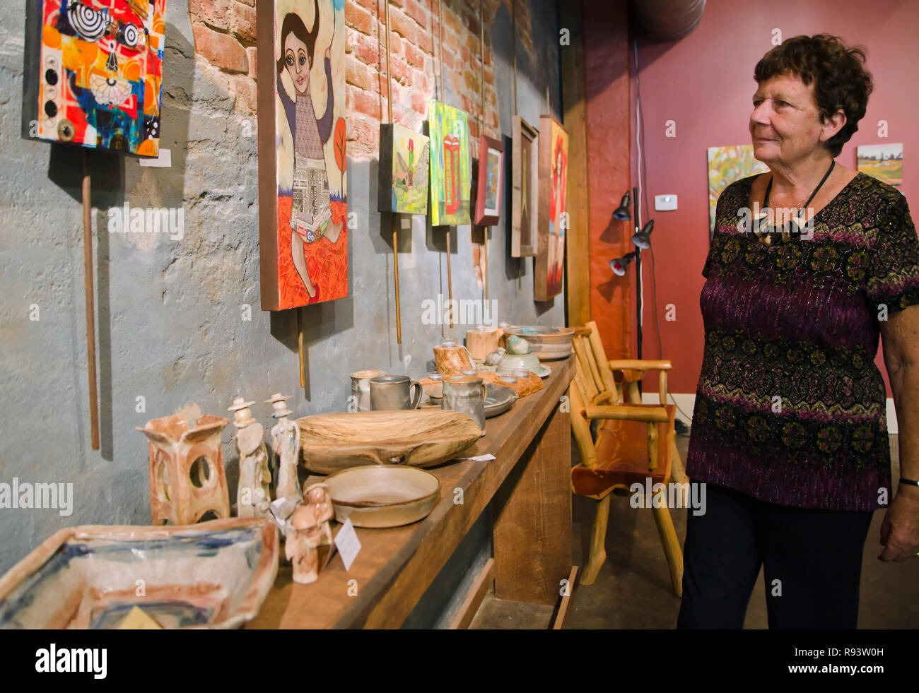 Artist Hanne Gaycken walks through Bozart's Gallery, where she is one of 15 artists who make up the Bozart's Alliance in Water Valley, Mississippi. Stock Photo