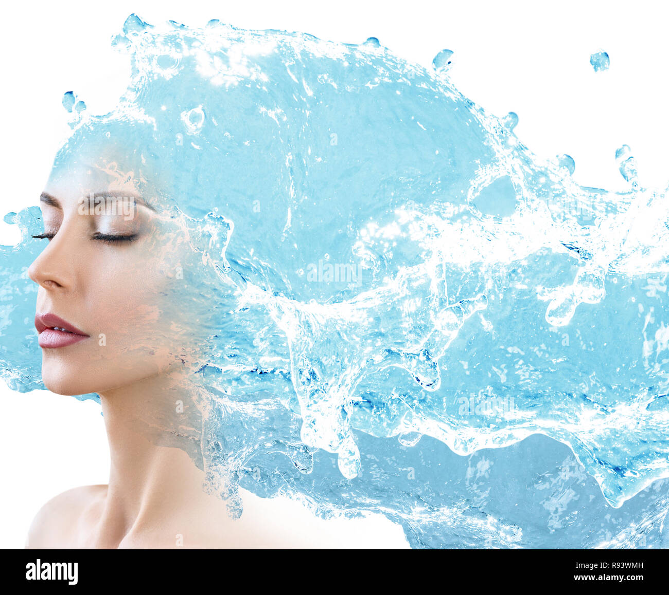 Female face appears from blue water splash. Stock Photo