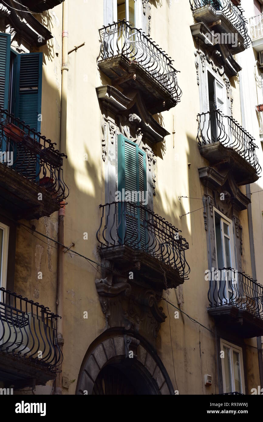 Metal forged ornamental railings on typical tiny balconies on traditional Mediterranean style apartment buildings. Stock Photo
