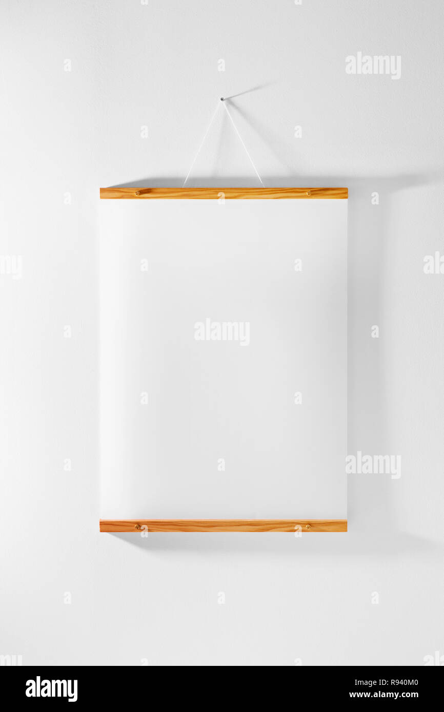 Wood frame poster hanging on wall Stock Photo