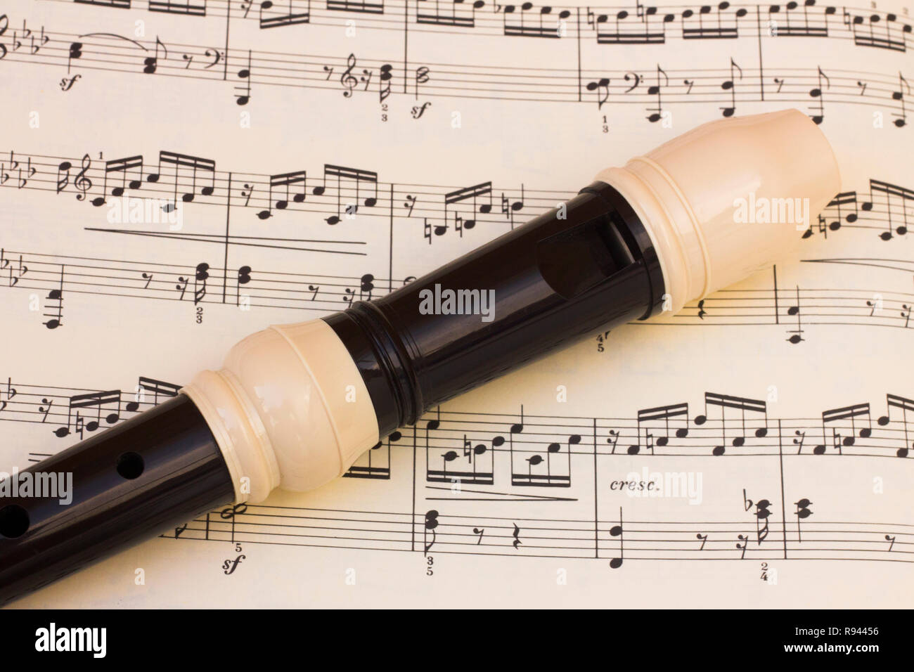 Plastic flute recorder over a music score sheet Stock Photo - Alamy