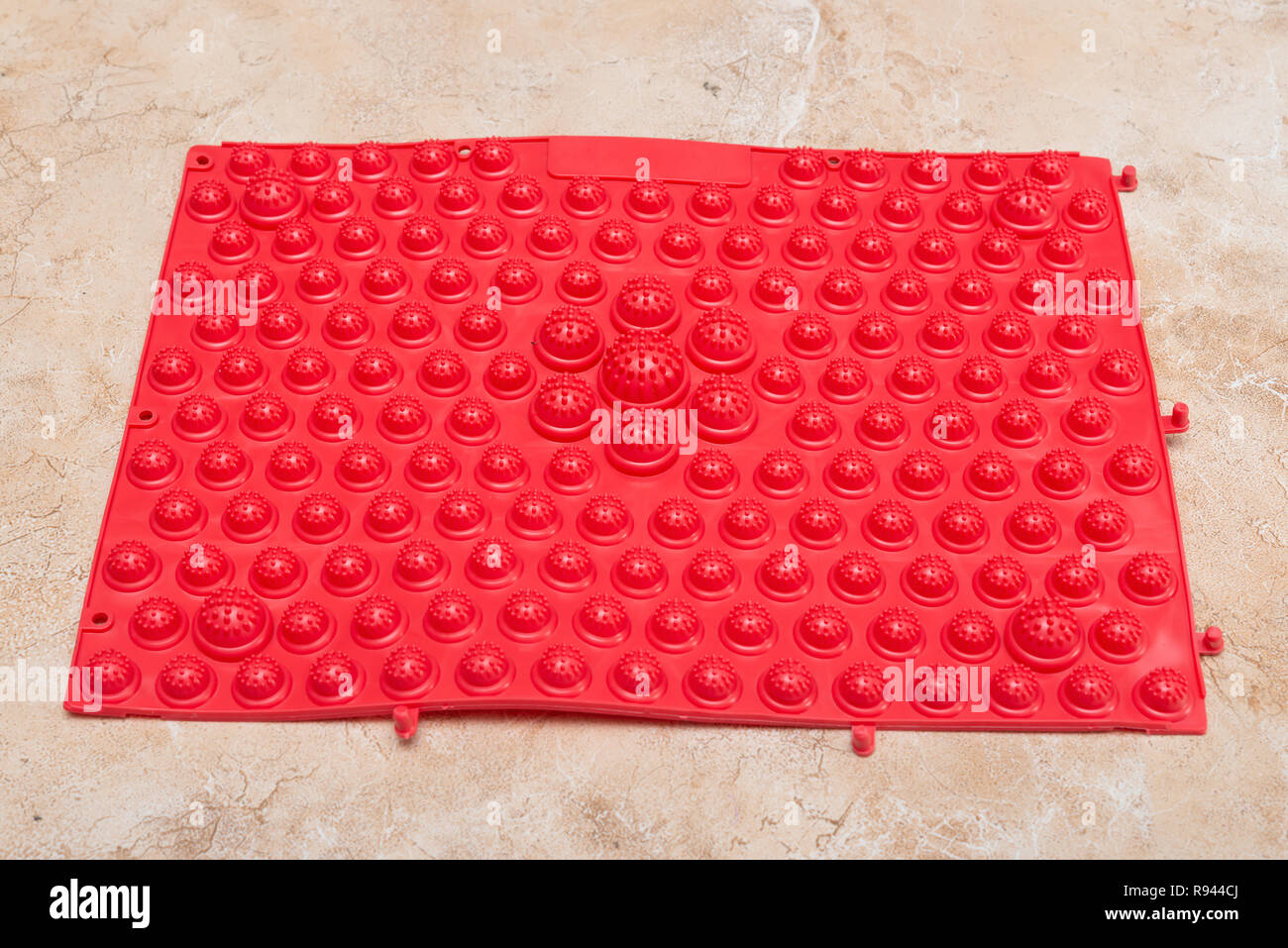 red foot massage pad with plastic domes on the floor Stock Photo Alamy