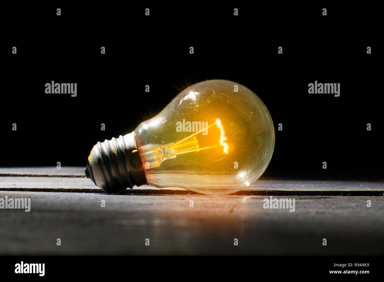 Old bulb stays lighting on. Old Vintage Lighting In The Dark Room. Idea