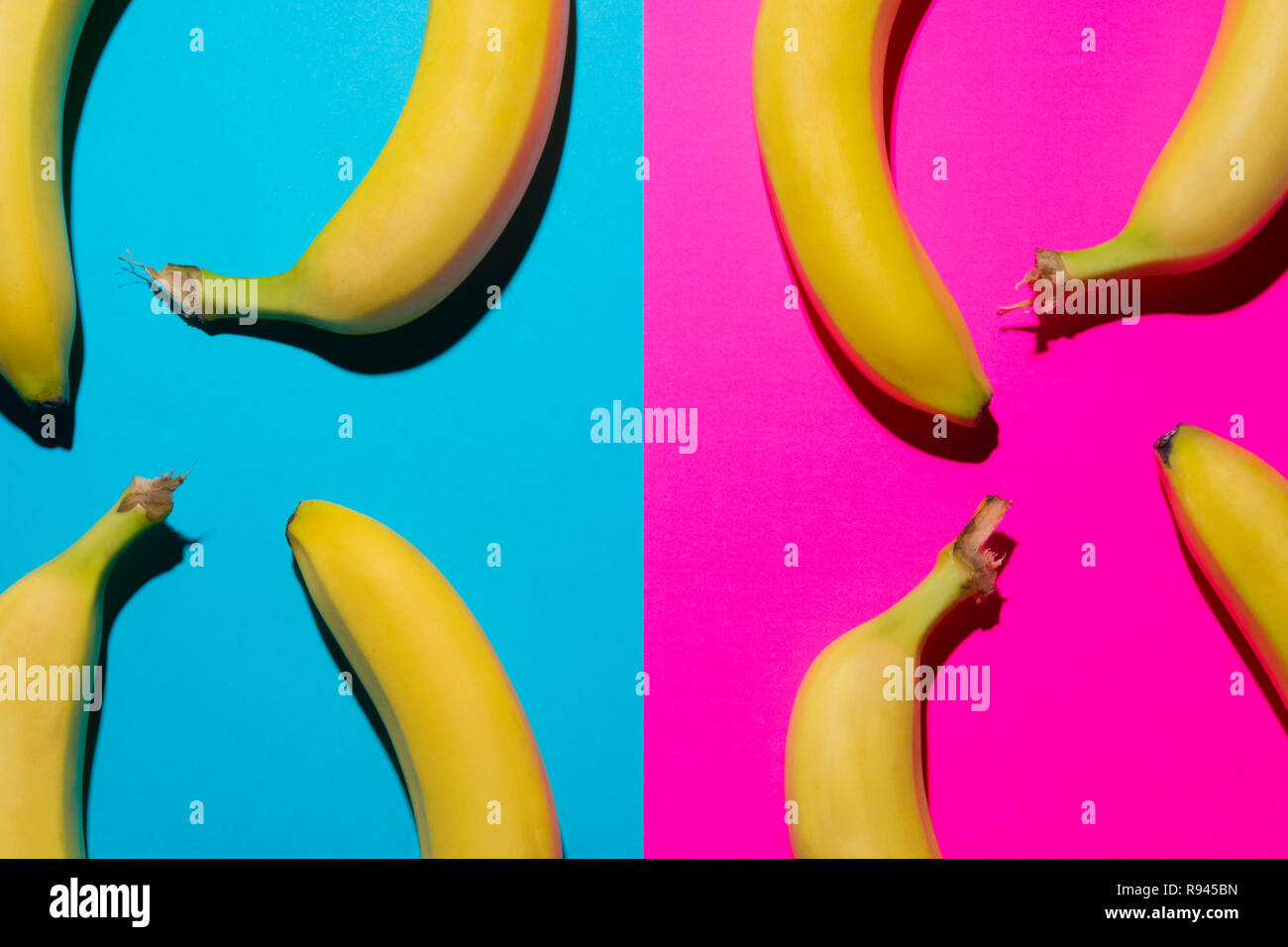Top view of bananas over yellow and blue background. Pop art design. Stock Photo