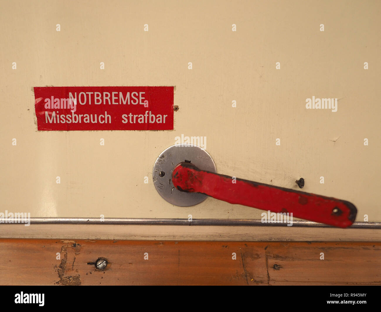 Notbremse, Missbrauch strafbar (meaning Emergengy brake, abuse punishable) sign on German tram Stock Photo