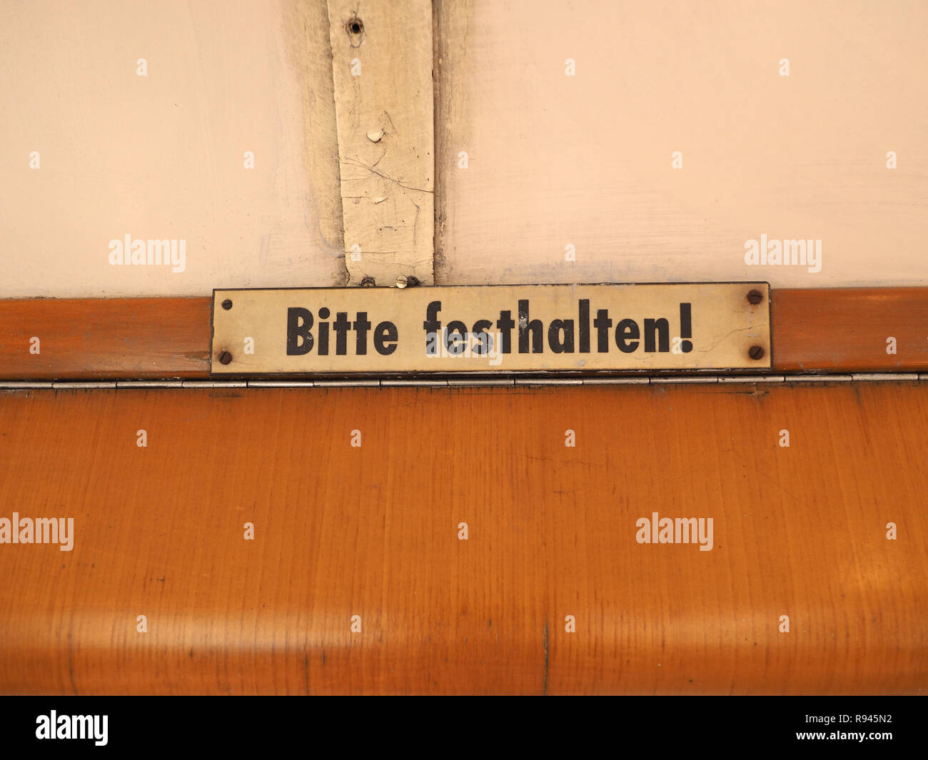 Bitte festhalten (meaning Please hold tight) sign on vintage German