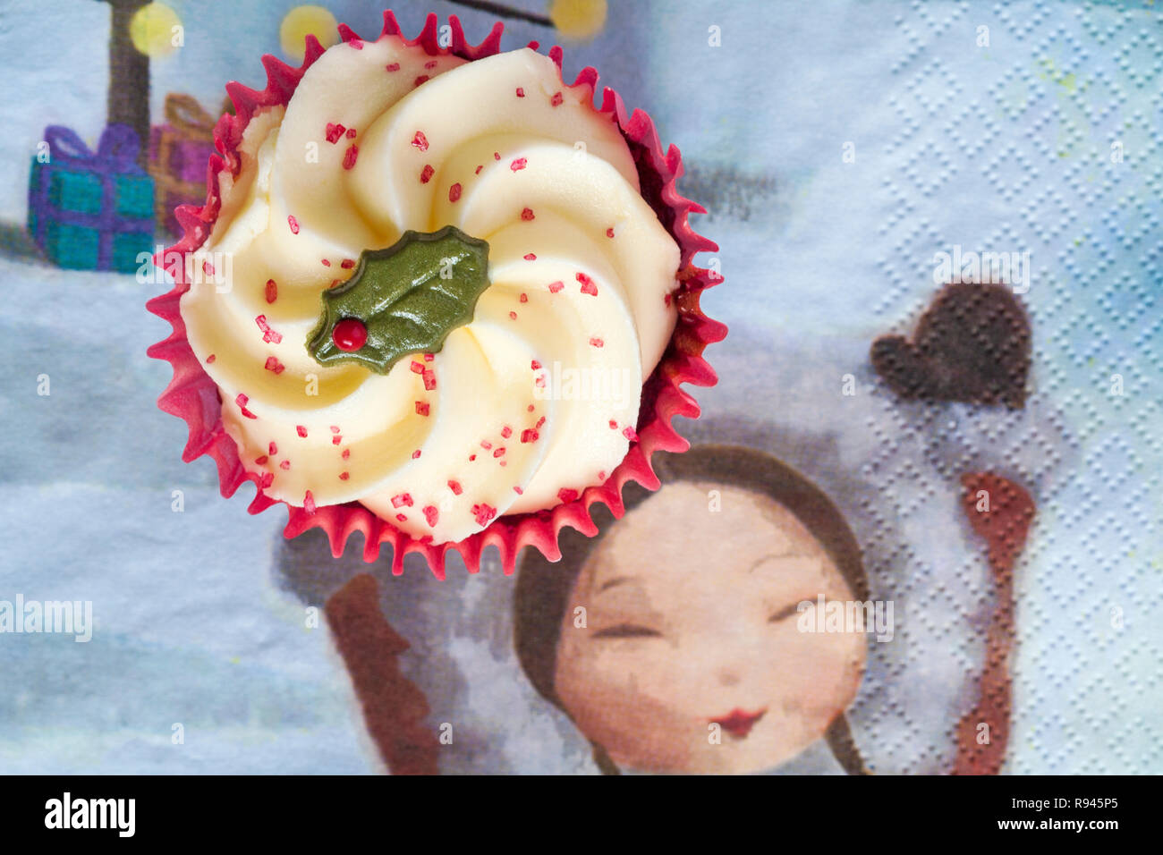 Sainsburys Red Velvet cupcake on serviette napkin with girl holding