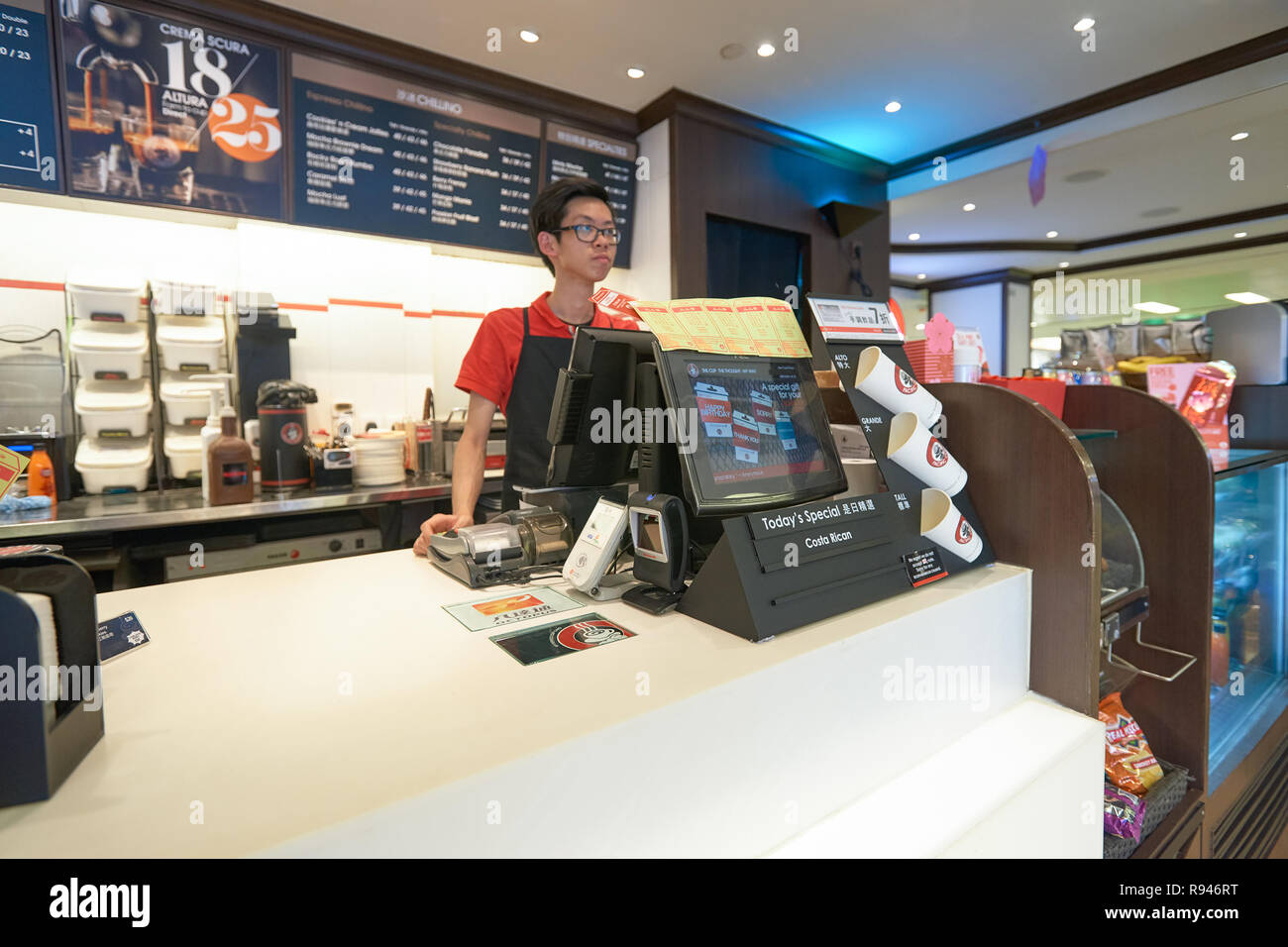 HONG KONG - JANUARY 28, 2016: young male cafe worker at Pacific Coffee. Stock Photo
