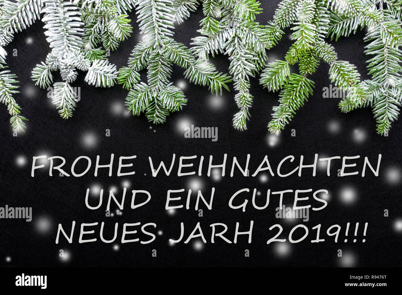 Fir tree and snow on dark background. Greetings Christmas card. Postcard. Christmastime. White and green.' frohe weihnachten und ein gutes neues jahr  Stock Photo