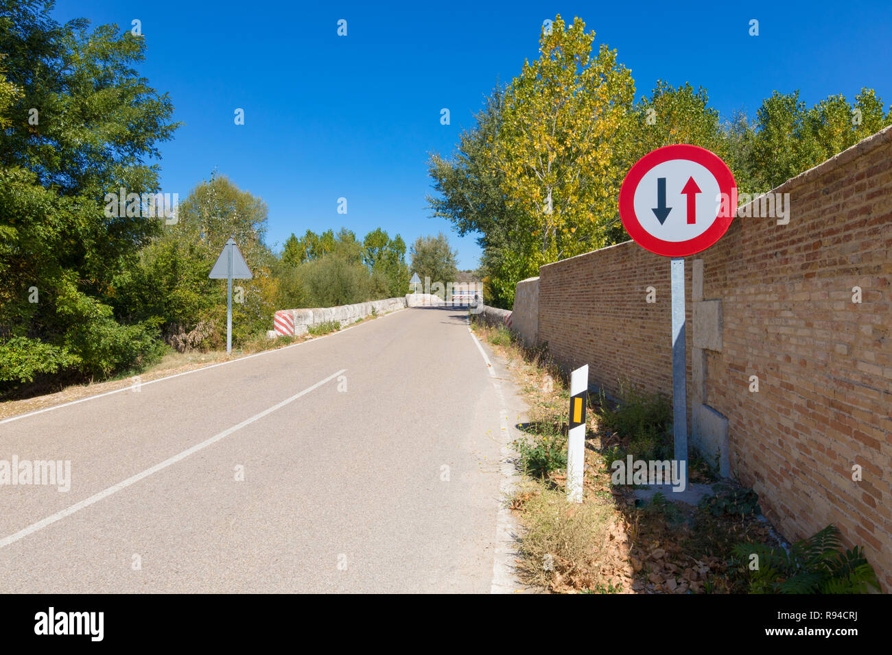 Spanish signal priority pass over oncoming vehicles in narrow rural road in Castile, Spain, Europe Stock Photo